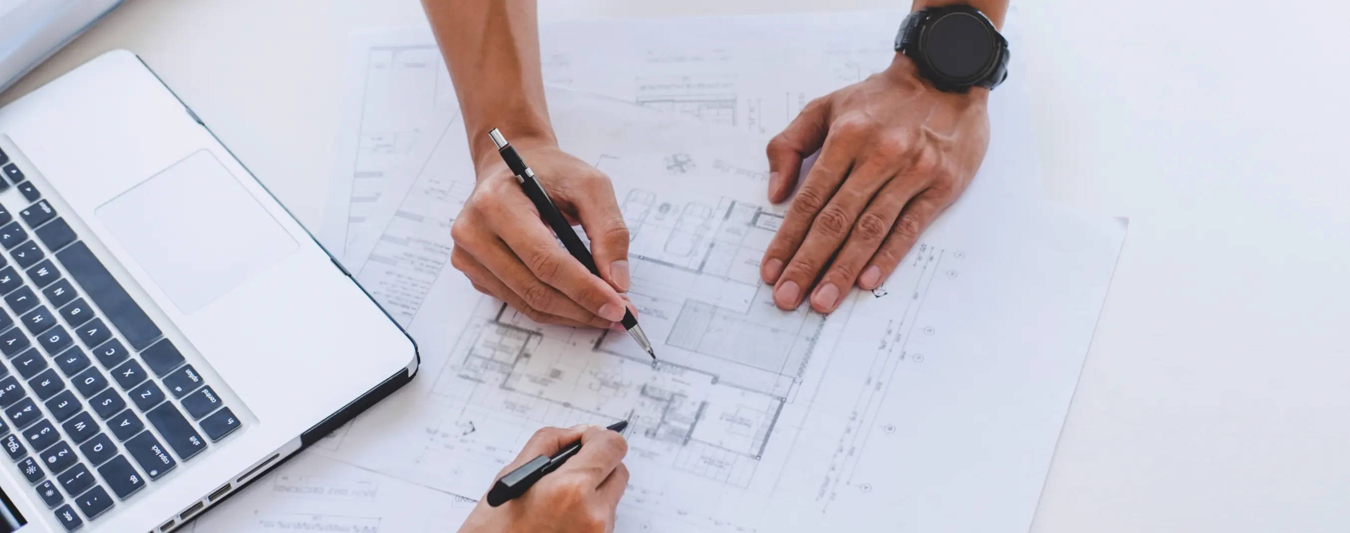 Man sketching in an architecture plan